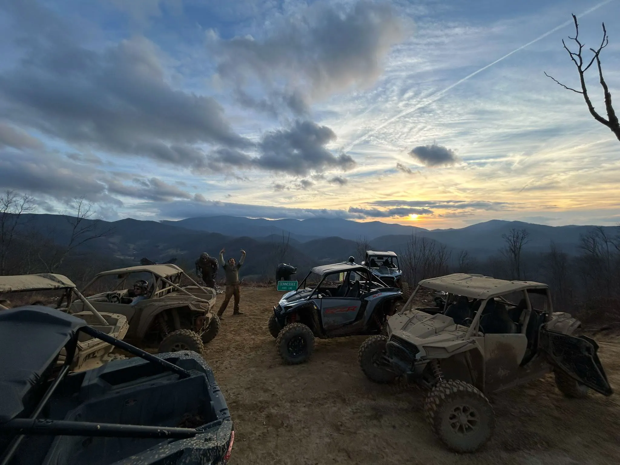 Riders at the summit overlook of our private mountain at sunset, Appalachian ridgelines behind